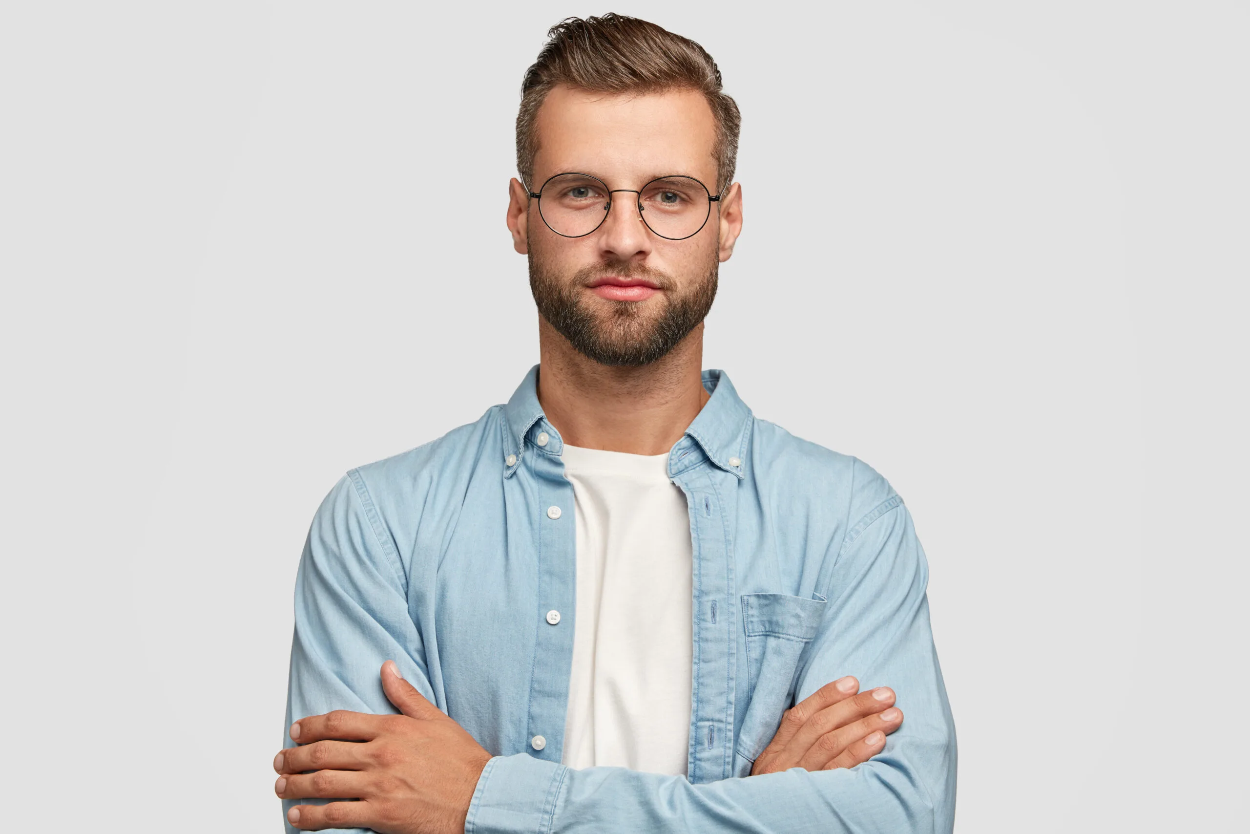 handsome bearded guy posing against white wall scaled
