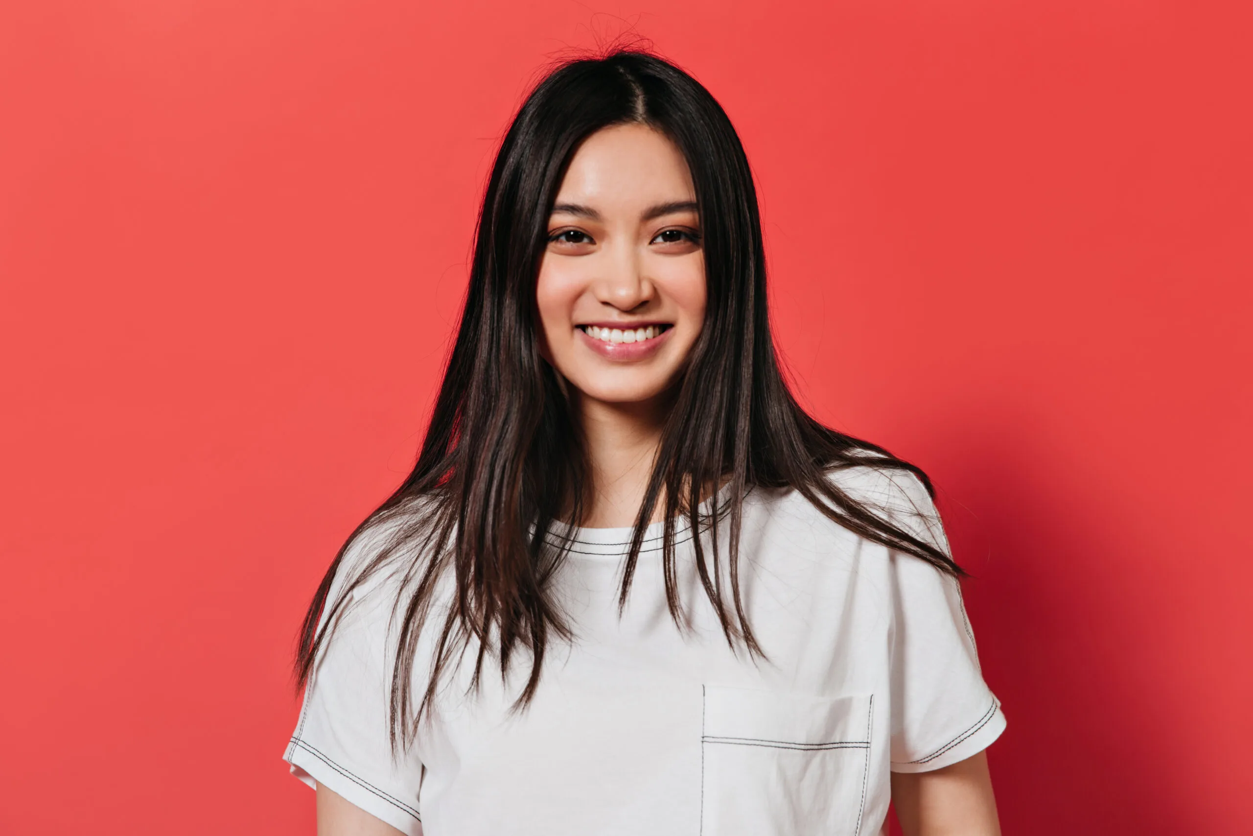 lady with brown eyes is smiling red wall scaled