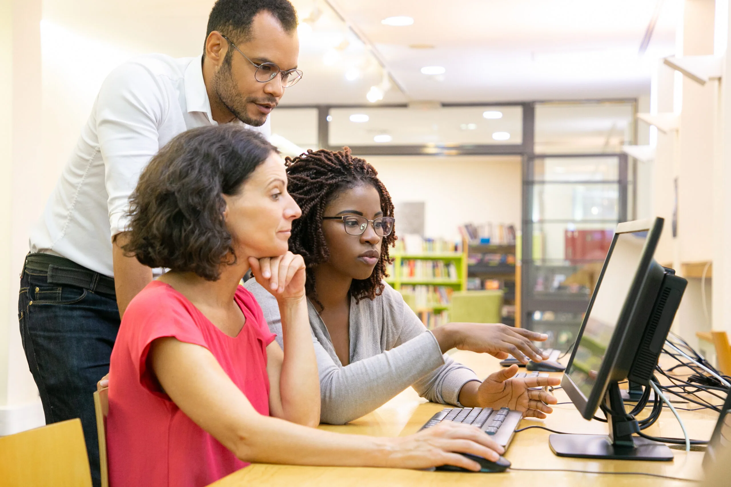 tutor helping students computer class scaled