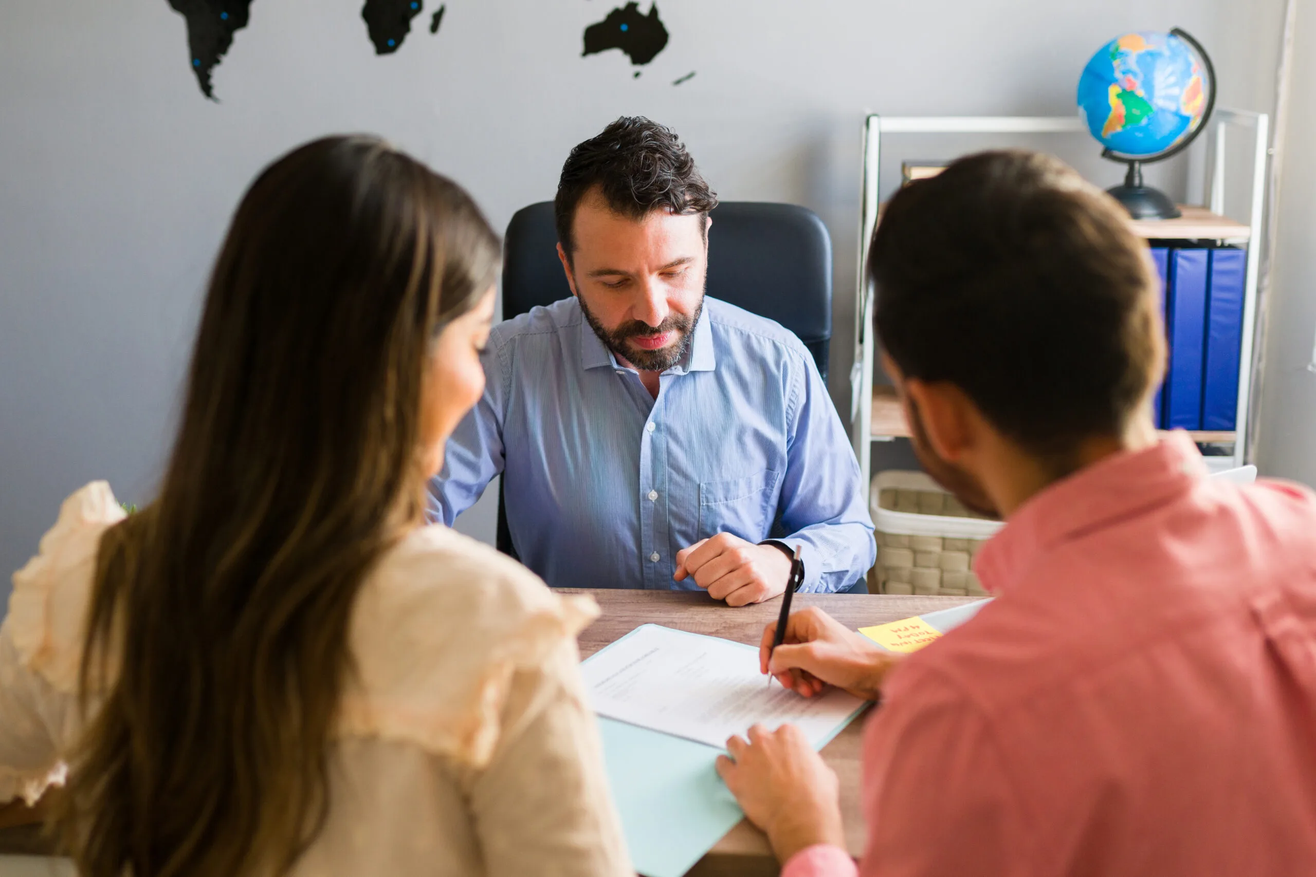 you got deal young man signing sales contract holiday vacation with his wife sales representative closing deal timeshare sale with some customers travel agency scaled